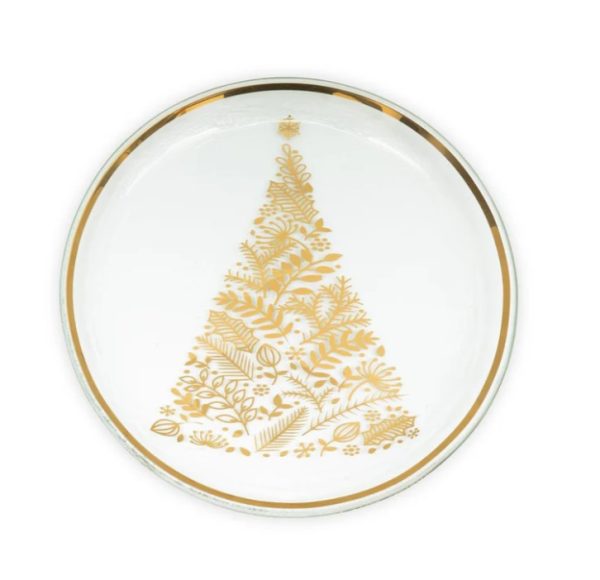 The Annieglass 2024 Christmas Plate is a round white plate adorned with a gold rim, featuring a gold decorative Christmas tree design made up of various botanical elements in the center.