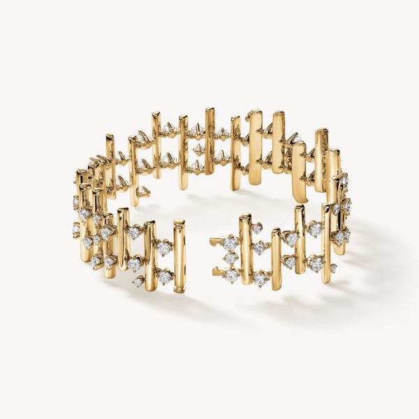 The Hearts on Fire Barre Multi-Row Bracelet is a gold cuff bracelet with an open design featuring vertical bars and small, sparkling diamond clusters throughout. It is displayed on a light background.