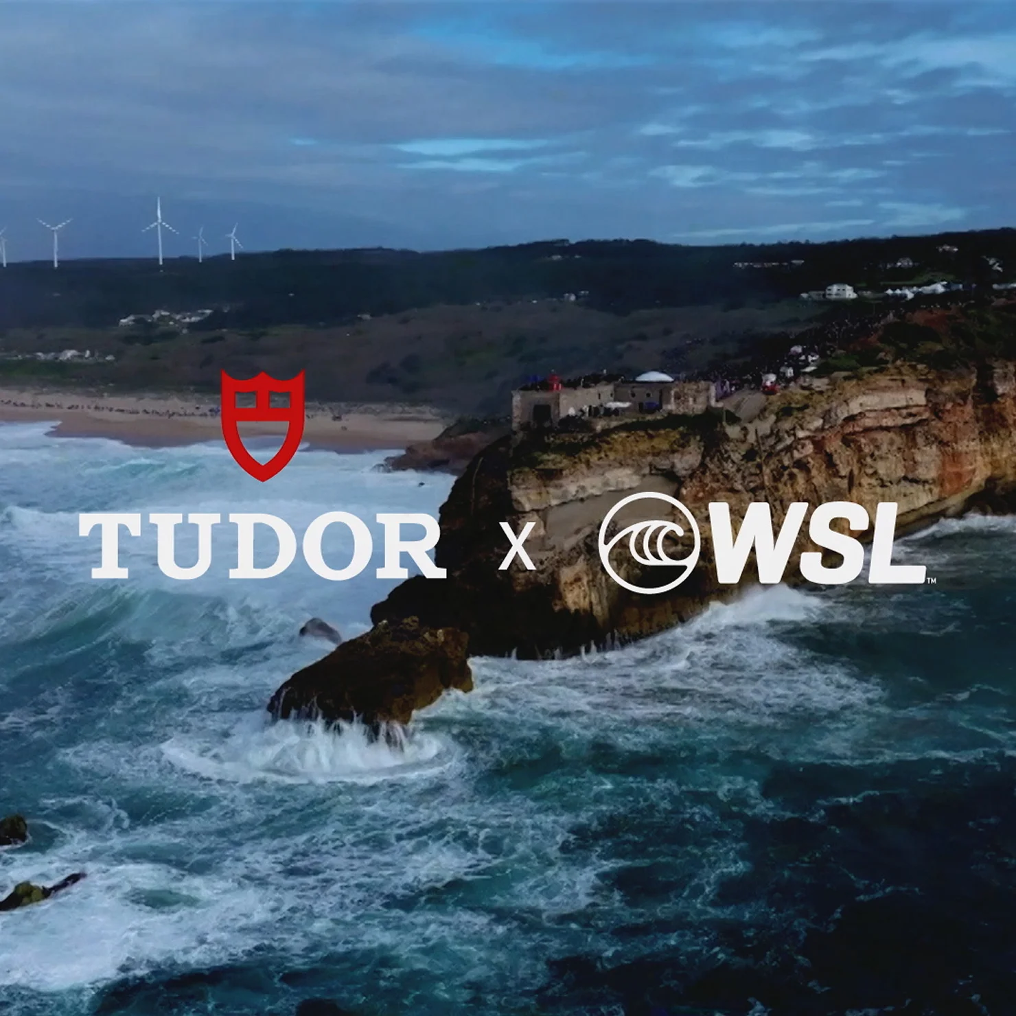 TUDOR and World Surf League logos over coastal cliff and ocean waves in Nazaré, Portugal